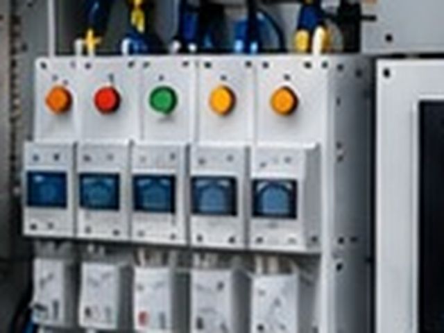 Close-up of an industrial control panel with PLC and wiring
